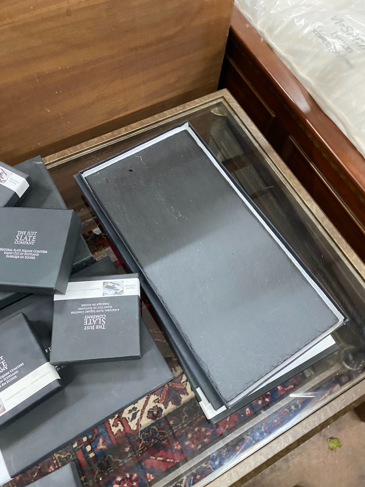 A quantity of 'The Just Slate Company' table mats, runners and coasters, all boxed